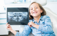 Child holds xray taken at orthodontic consultation